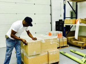 RICHARD, PRODUCTION MANAGER, OVERSEES PACKING OF LARGE ORDERS